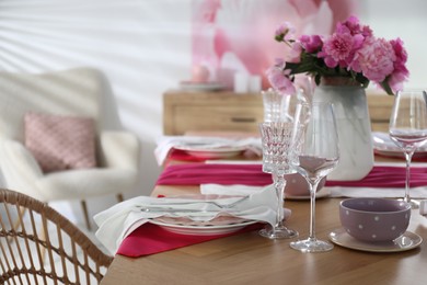 Beautiful table setting with pink peonies in dining room