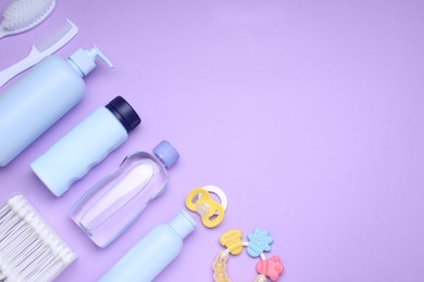 Photo of Flat lay composition with baby care products and accessories on lilac background, space for text