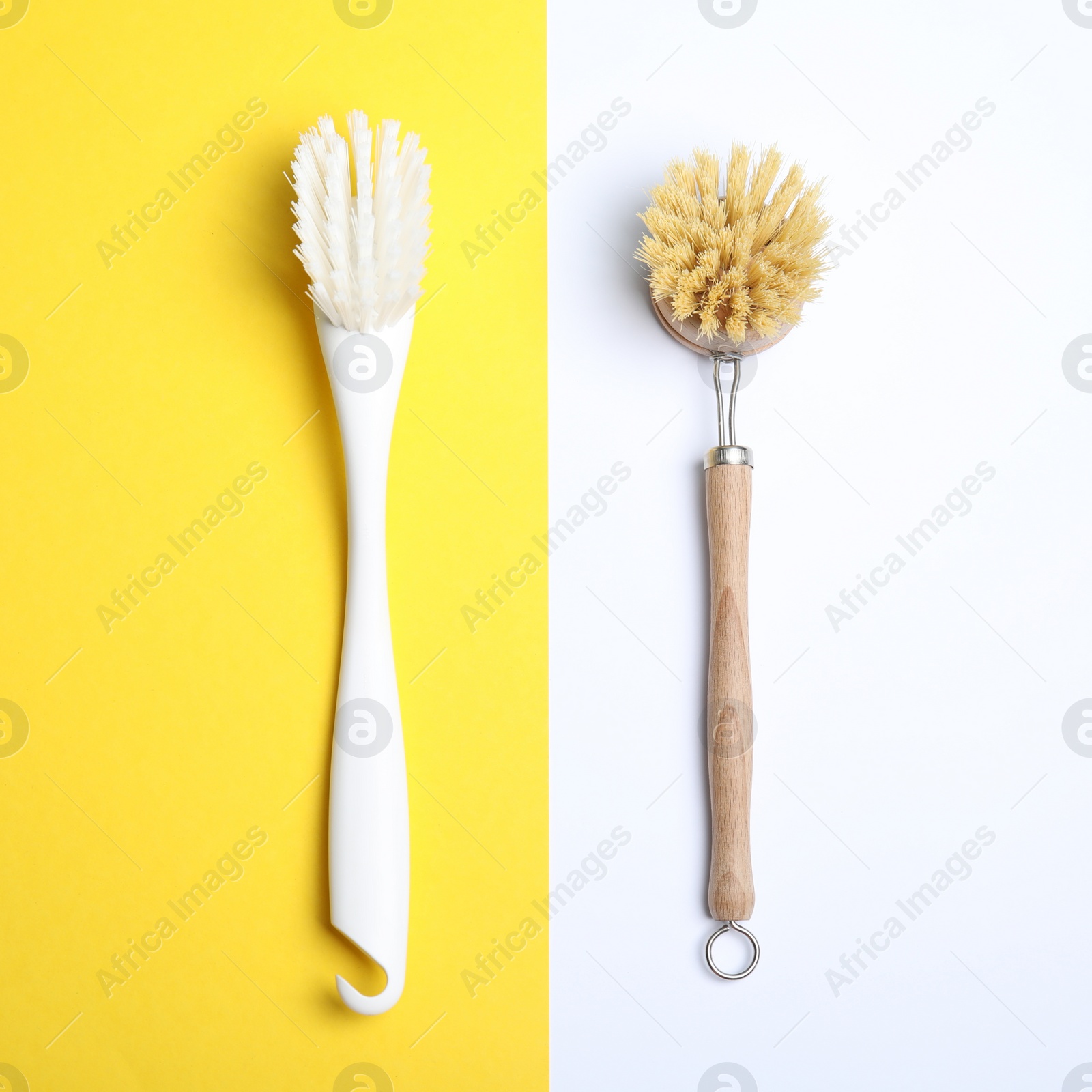 Photo of Cleaning brushes for dish washing on color background, flat lay