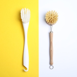 Photo of Cleaning brushes for dish washing on color background, flat lay