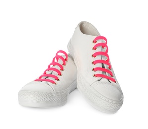 Photo of Sportive shoes with pink silicone laces on white background
