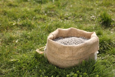 Fertilizer in bag on green grass outdoors