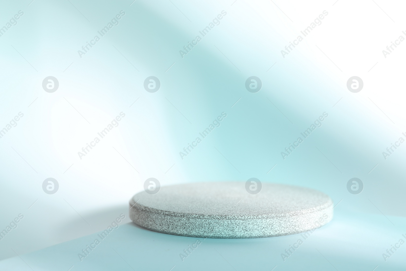 Photo of Presentation of product. Stone podium on light blue background, space for text
