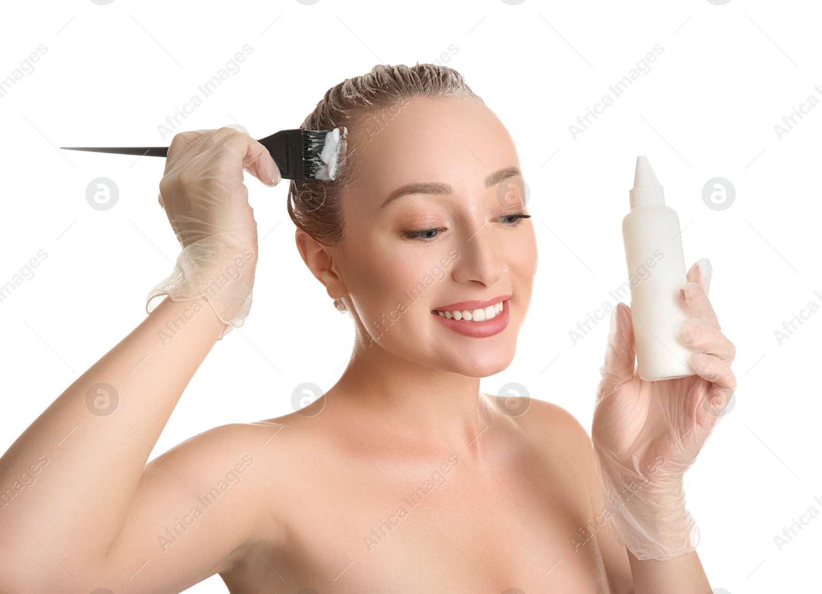 Photo of Young woman dyeing her hair against white background