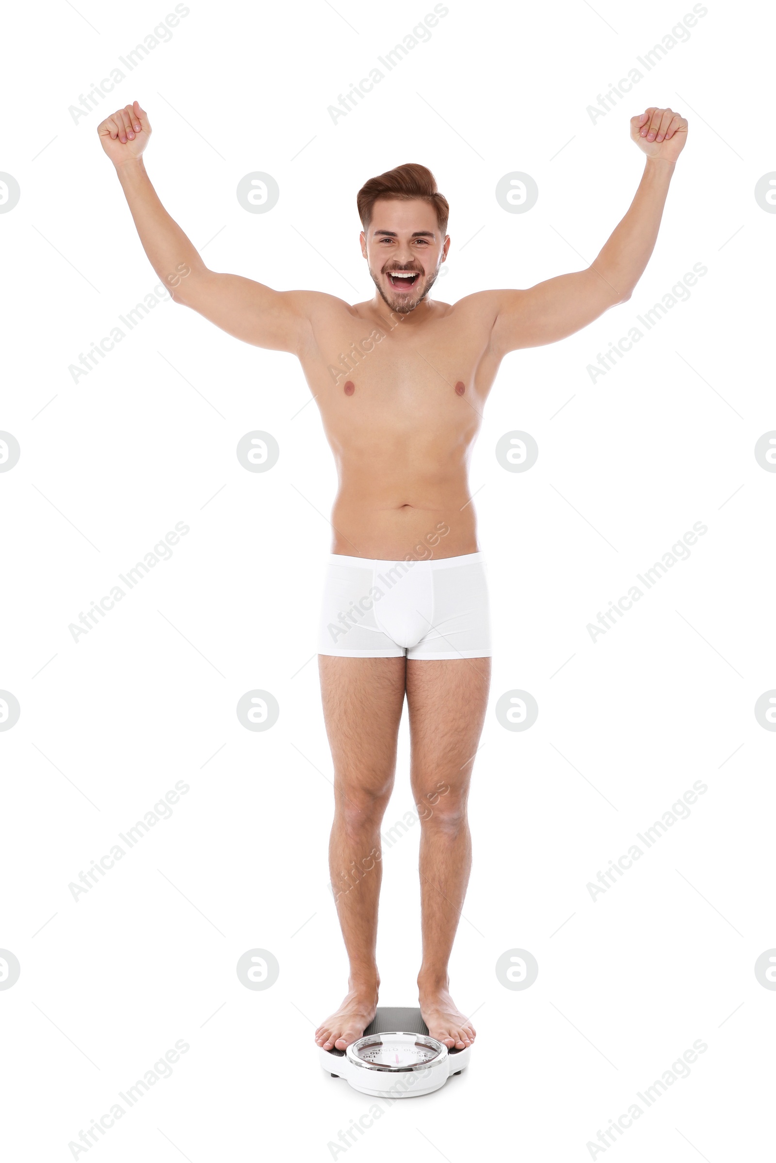 Photo of Fit man standing on bathroom scale against white background. Weight loss