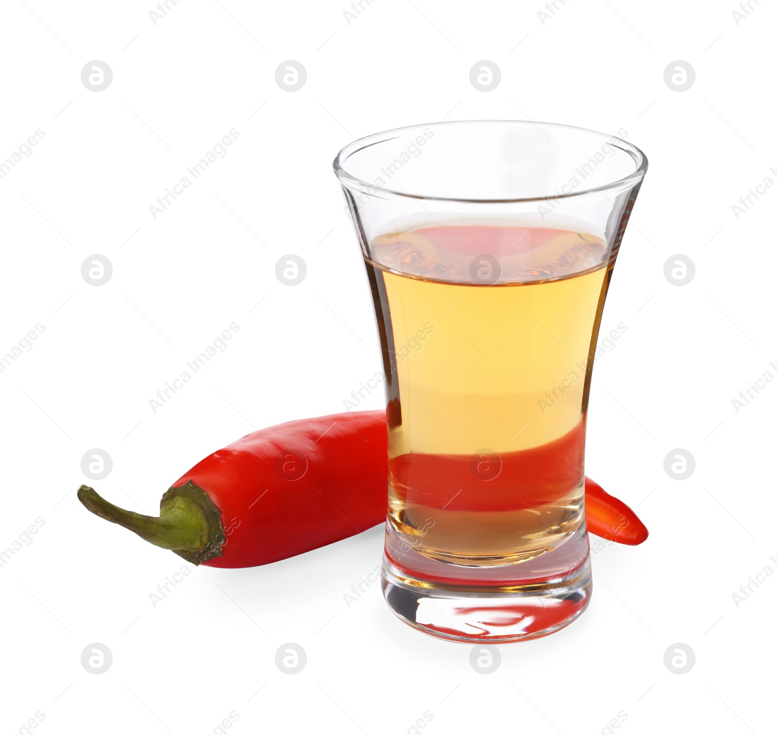 Photo of Red hot chili pepper and vodka in shot glass on white background