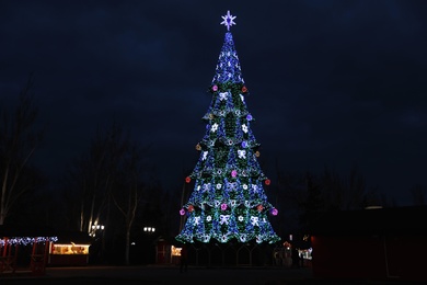 Beautiful decorated Christmas tree outdoors. Bokeh effect