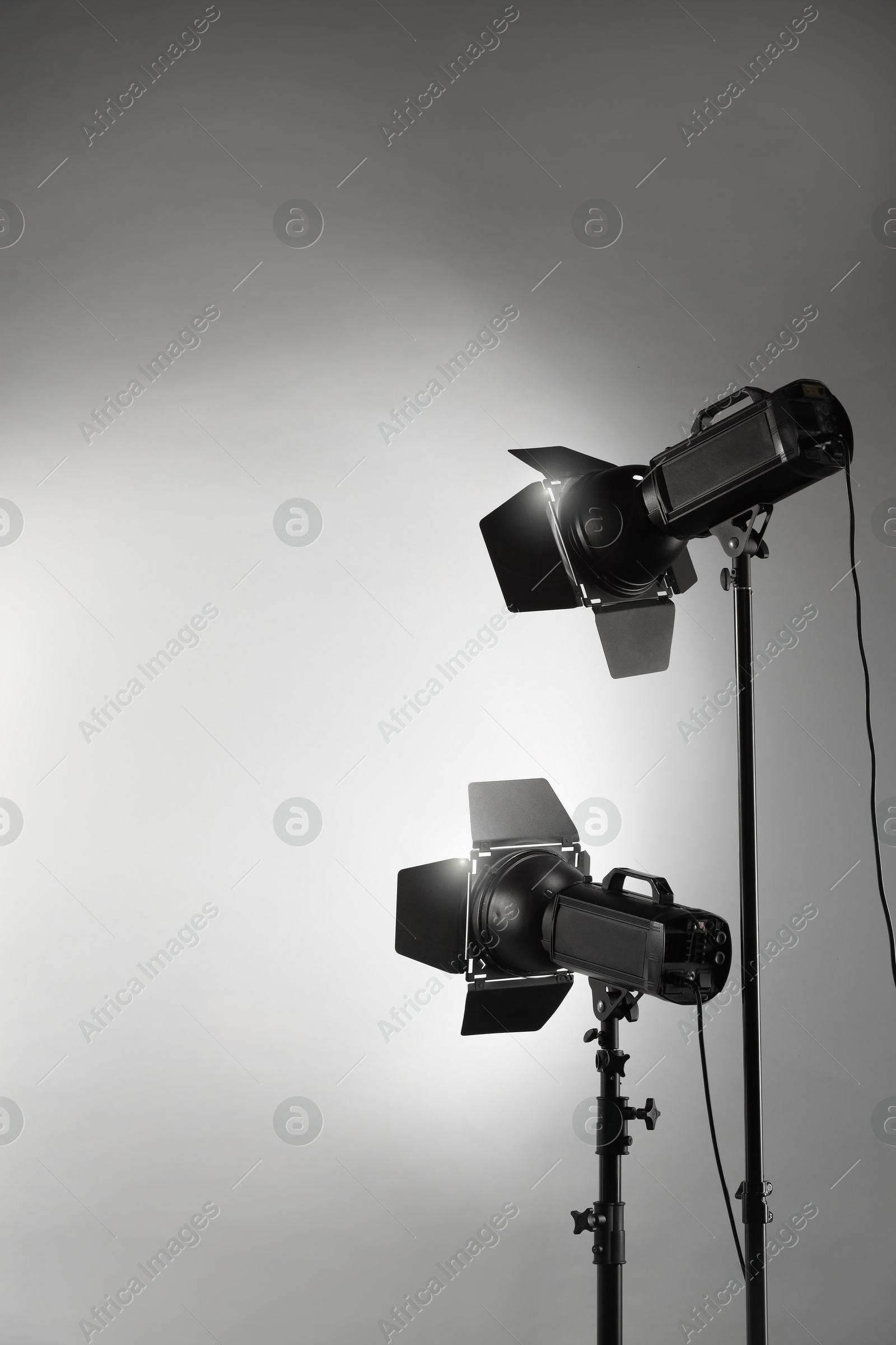 Photo of Grey photo background and professional lighting equipment in studio