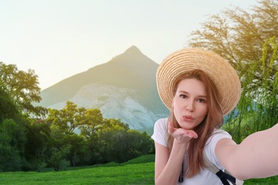 Image of Beautiful woman in straw hat taking selfie in mountains