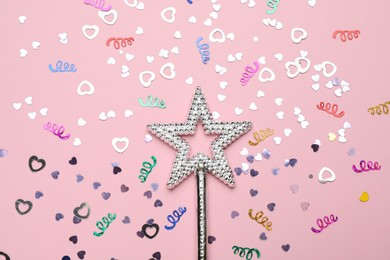 Photo of Beautiful silver magic wand and confetti on pink background, flat lay