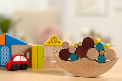 Photo of Wooden balance toy on table, closeup. Space for text. Children's development