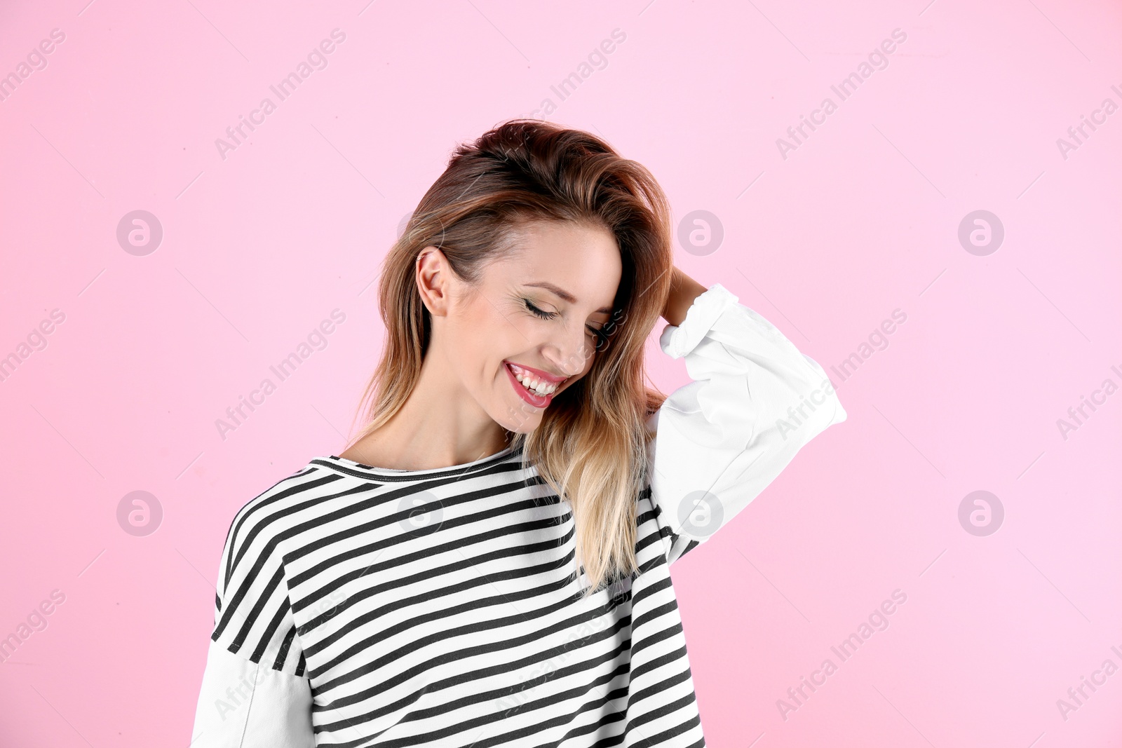 Photo of Portrait of beautiful laughing woman on color background