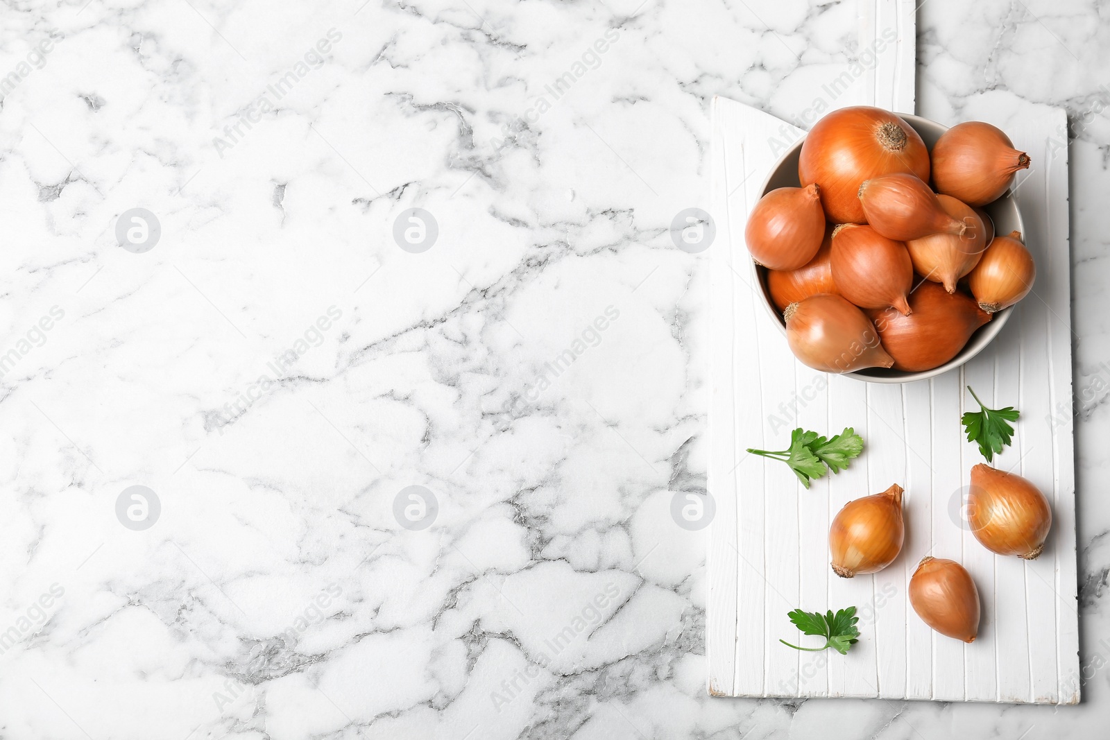 Photo of Flat lay composition with fresh ripe onions on marble table