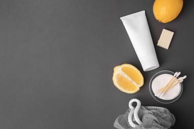 Lemon face wash. Fresh citrus fruits and personal care products on dark grey background, flat lay. Space for text