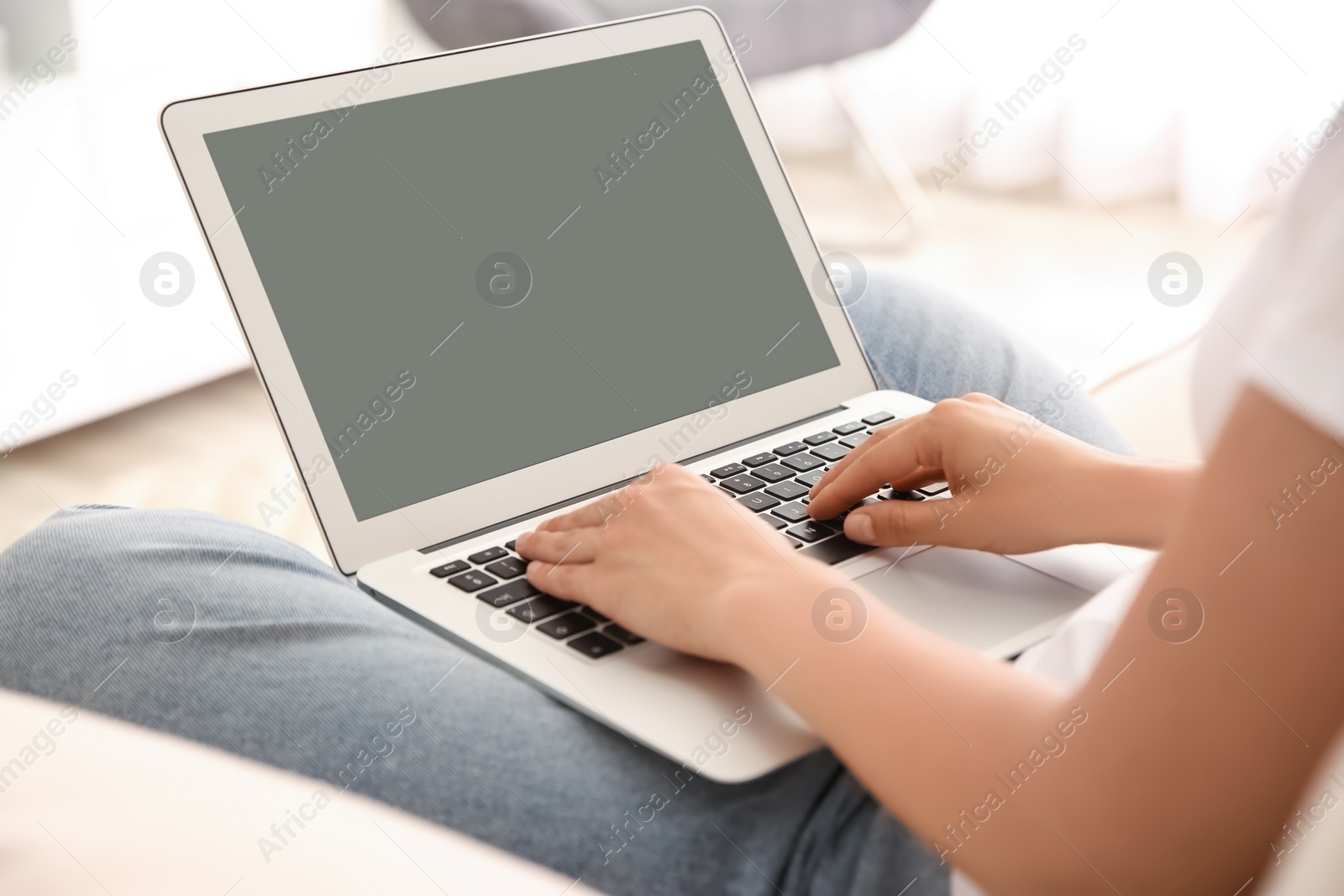 Photo of Woman working with modern laptop indoors, closeup. Space for design