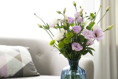Photo of Bouquet of beautiful Eustoma flowers in room, closeup. Space for text