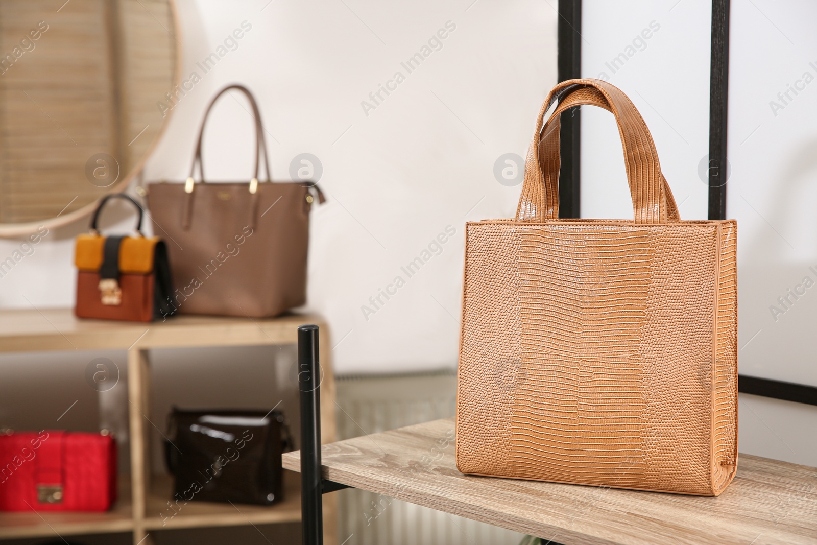 Photo of Leather woman's bag on wooden shelf in store