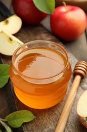 Photo of Sweet honey and fresh apples on wooden table