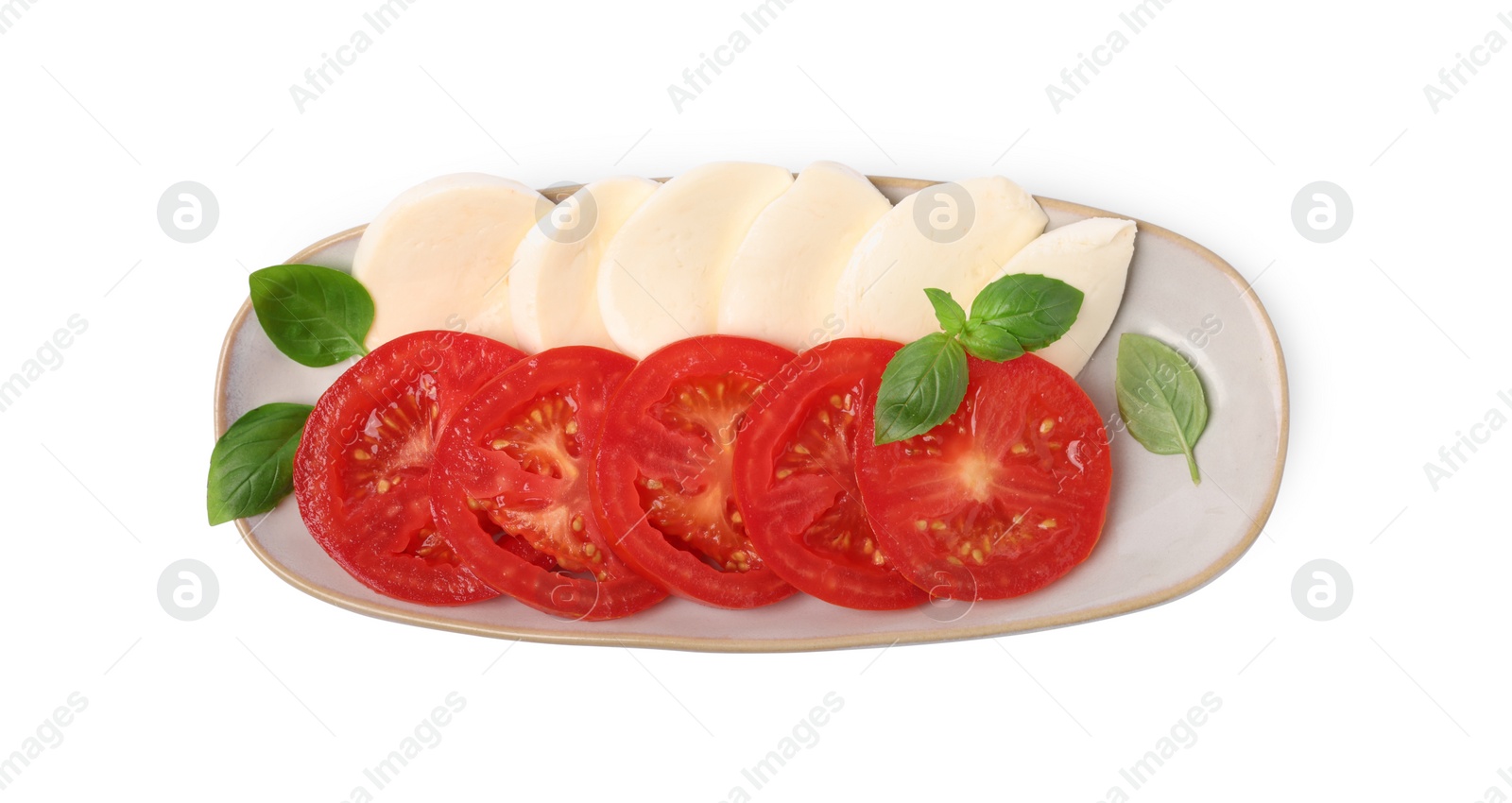 Photo of Plate of delicious Caprese salad with tomatoes, mozzarella and basil isolated on white, top view