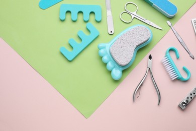 Photo of Set of pedicure tools on color background, flat lay. Space for text