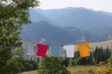 Washing line with clean laundry and clothespins in mountains