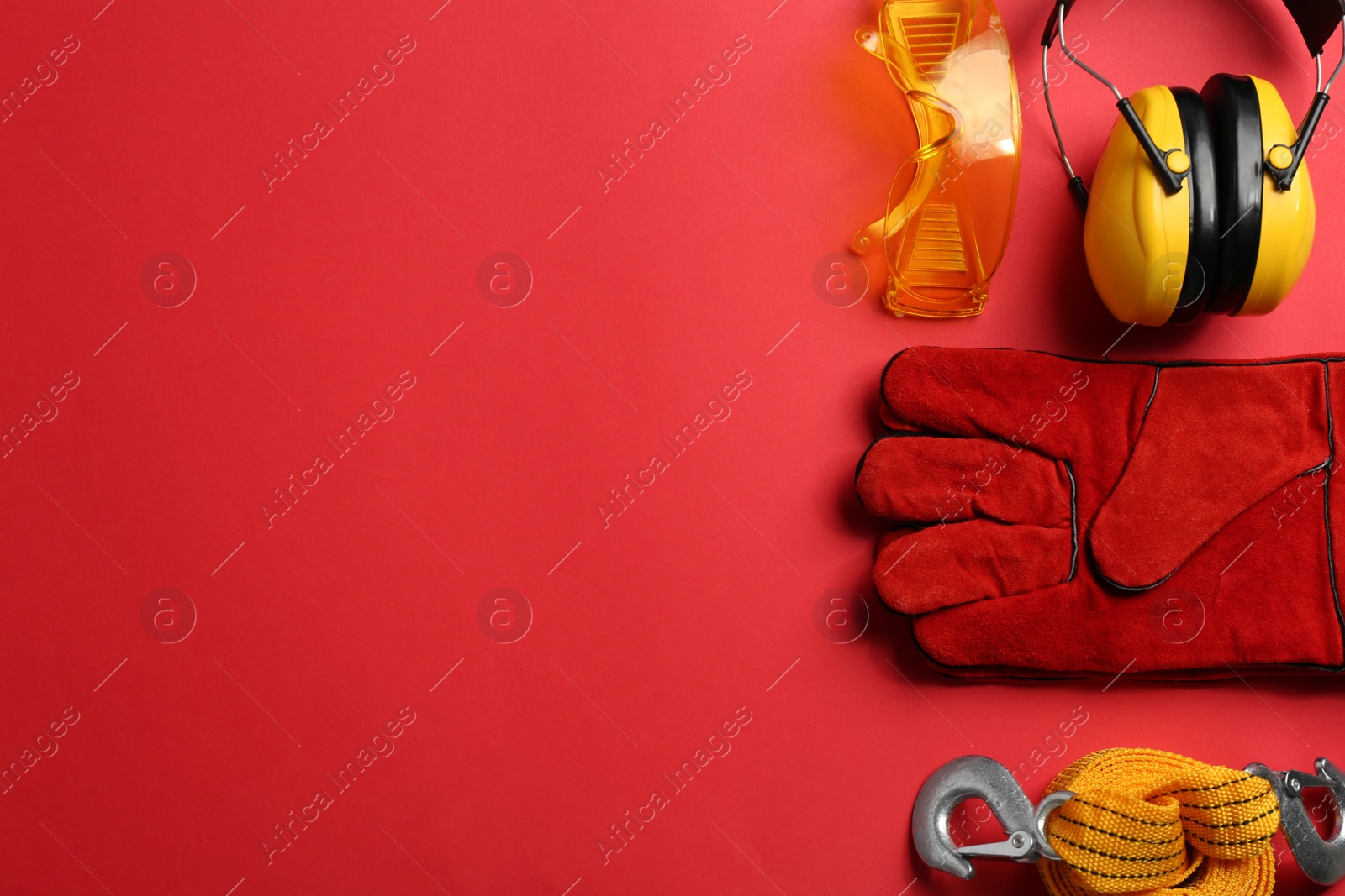 Photo of Flat lay composition with safety equipment and space for text on color background