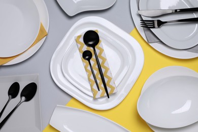 Photo of Different plates and cutlery on color background, flat lay
