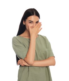 Embarrassed woman covering face with hand on white background