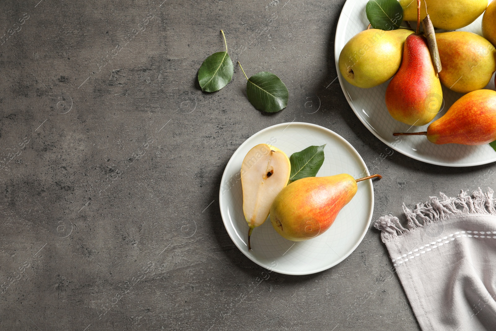 Photo of Flat lay composition with ripe pears on grey background. Space for text