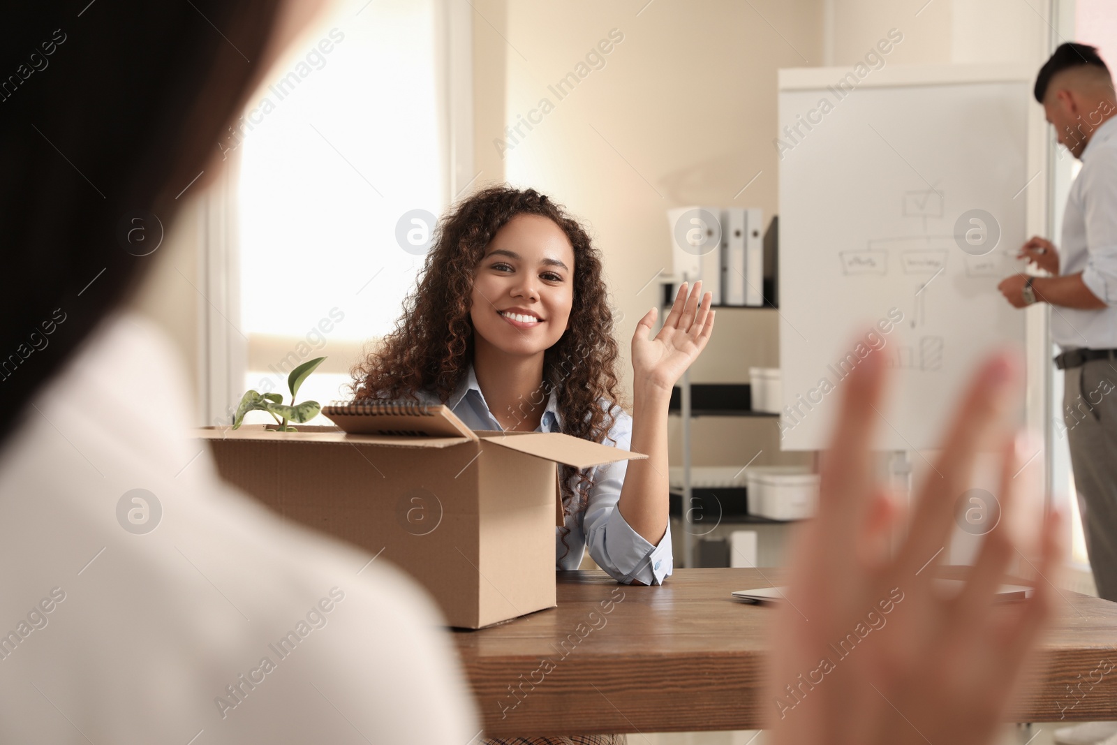 Photo of Employee greeting new coworker in modern office