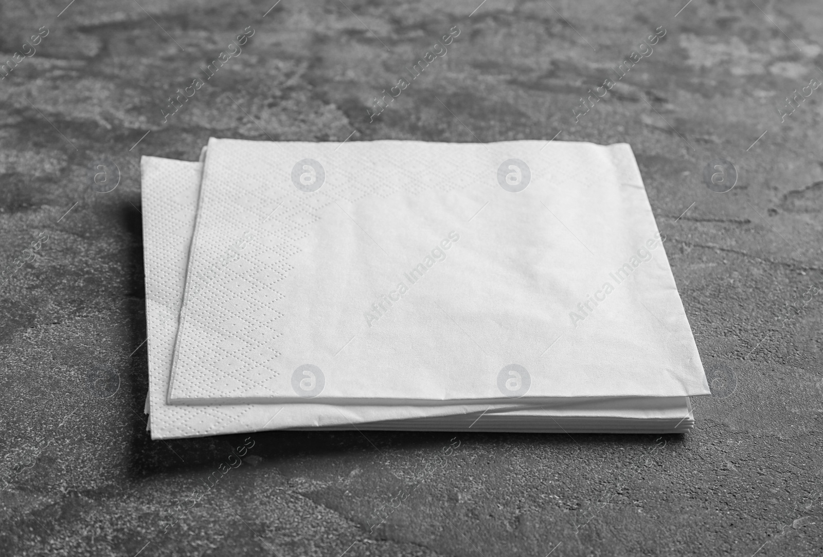 Photo of Clean napkins on grey background. Personal hygiene