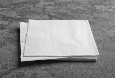 Clean napkins on grey background. Personal hygiene