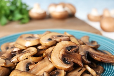 Photo of Plate of tasty fried mushrooms, closeup view