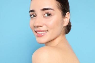 Photo of Portrait of young woman with beautiful face against color background