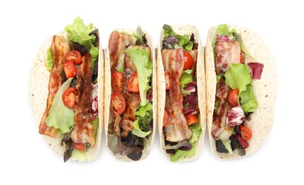 Photo of Delicious tacos with fried bacon and tomatoes on white background, top view