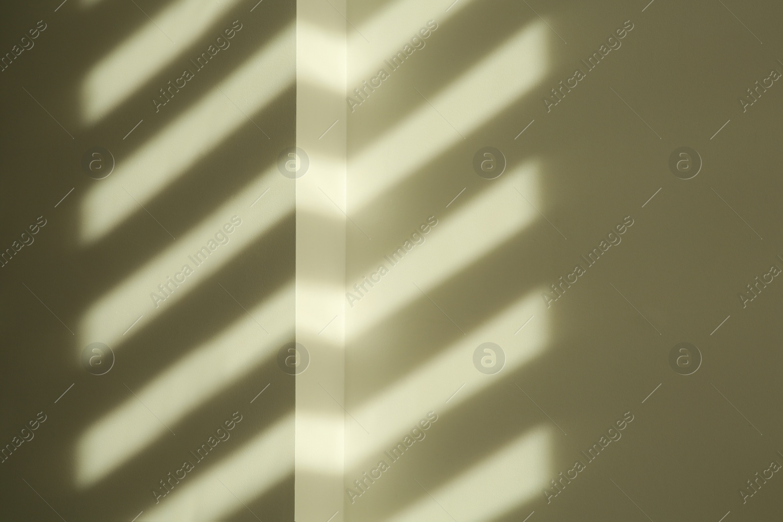 Photo of Lines made of light and shadows on white wall