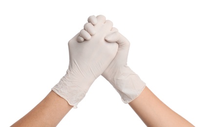 Doctors in medical gloves shaking hands on white background, closeup
