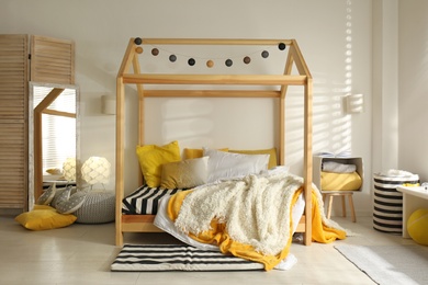 Photo of Cozy child room interior with comfortable bed