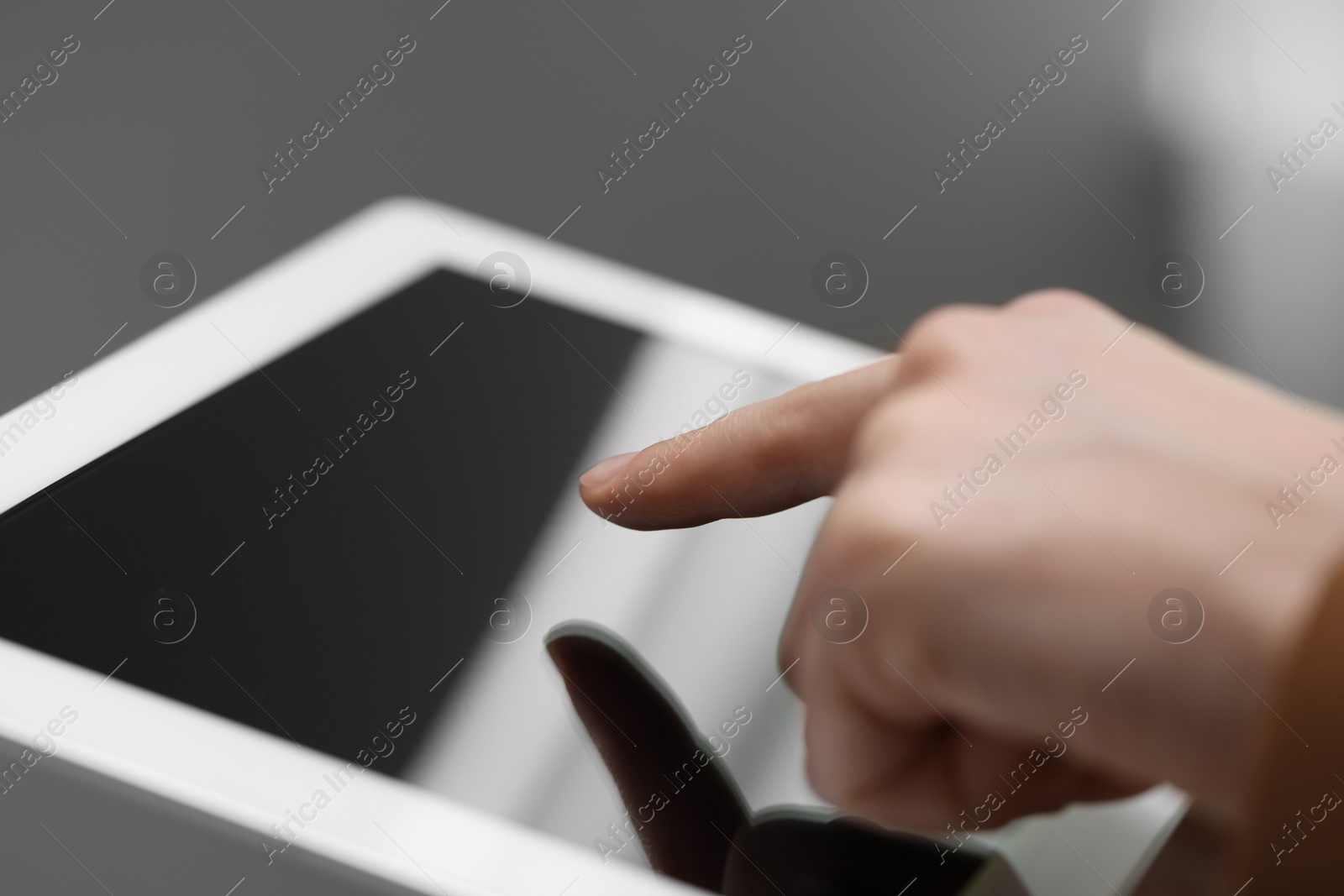 Photo of Closeup view of woman using modern tablet on blurred background