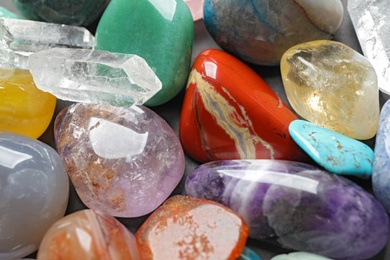 Photo of Different precious gemstones as background, closeup view