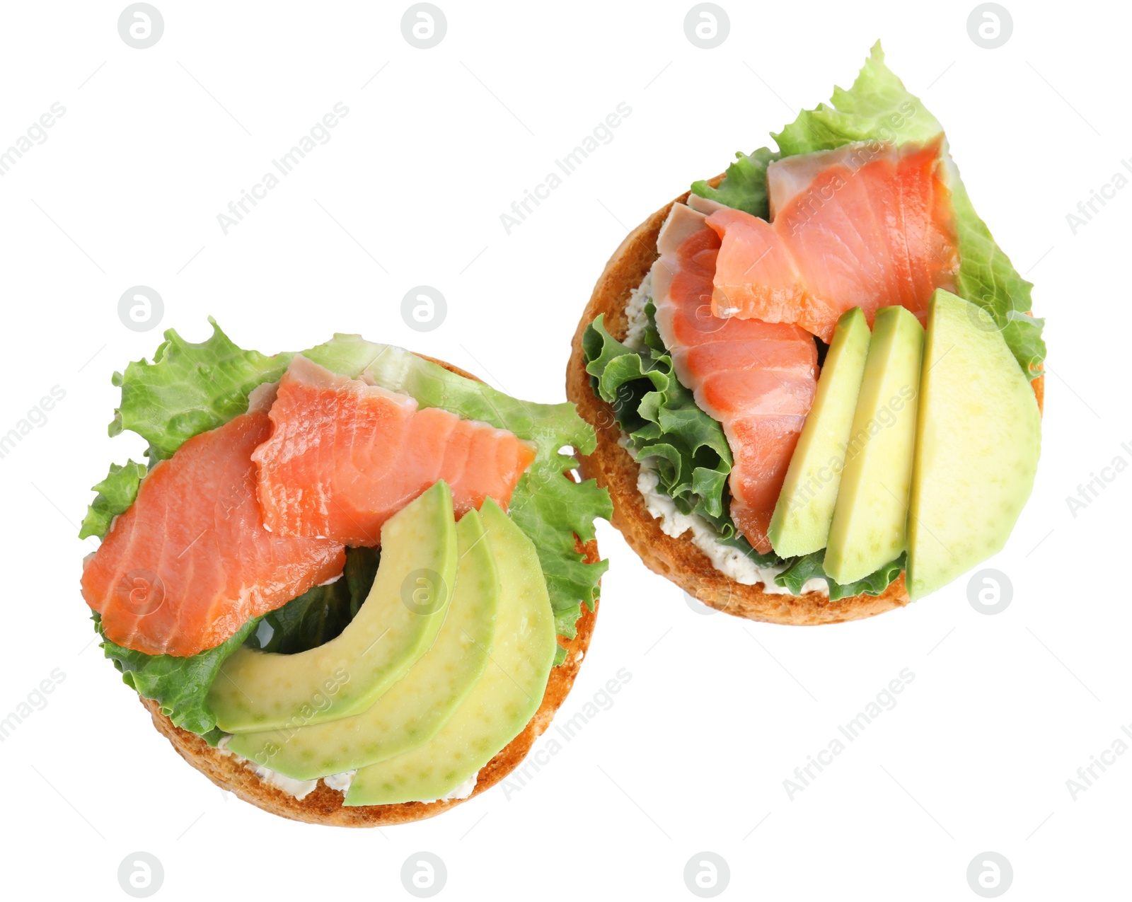 Photo of Tasty rusks with salmon, cream cheese and avocado isolated on white, top view