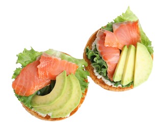Photo of Tasty rusks with salmon, cream cheese and avocado isolated on white, top view