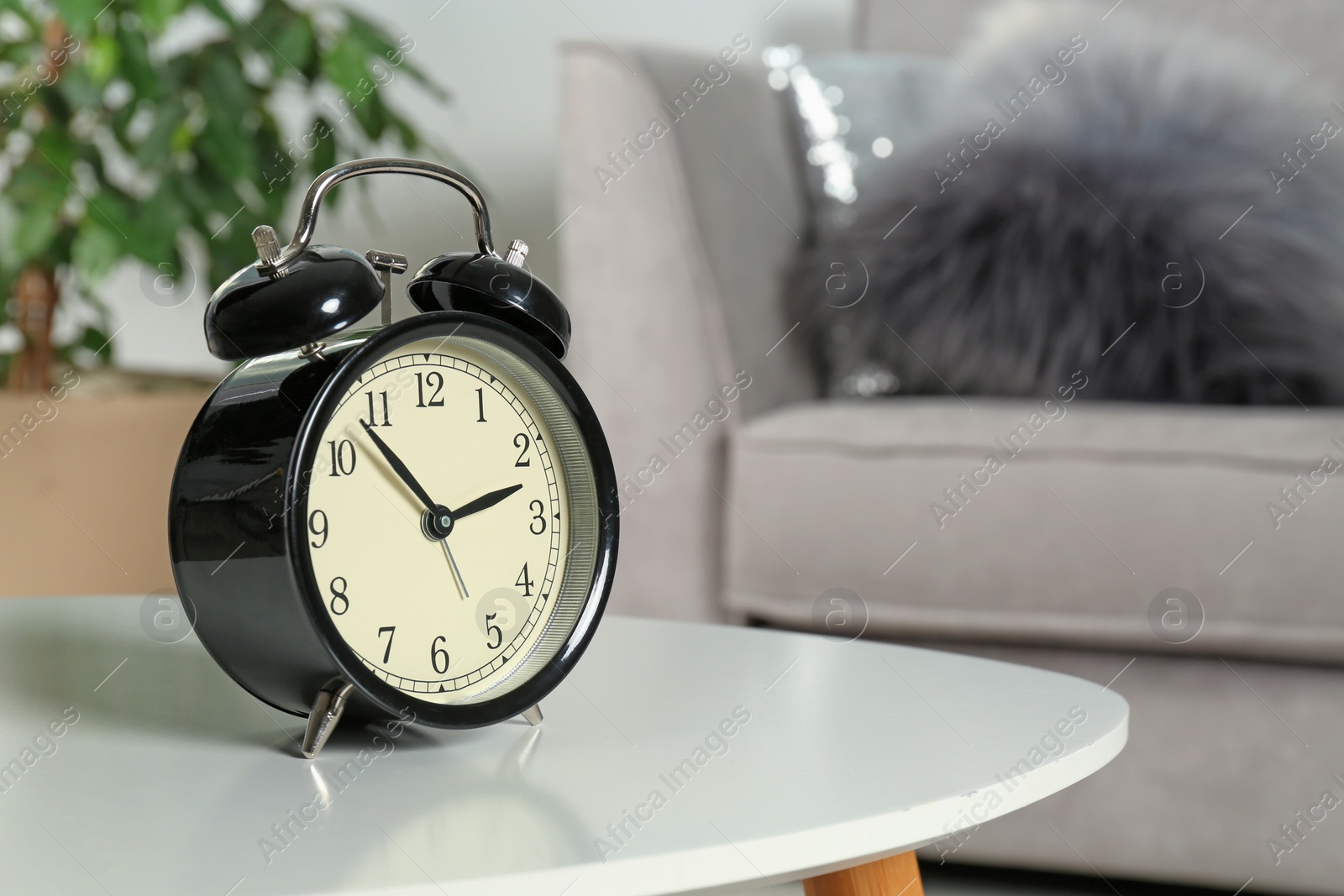 Photo of Alarm clock on table indoors, space for text. Time management