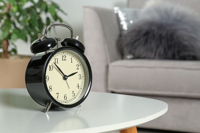 Alarm clock on table indoors, space for text. Time management