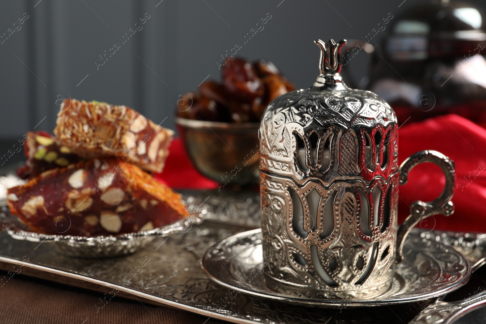 Photo of Tea, Turkish delight and date fruits served in vintage tea set on table, space for text