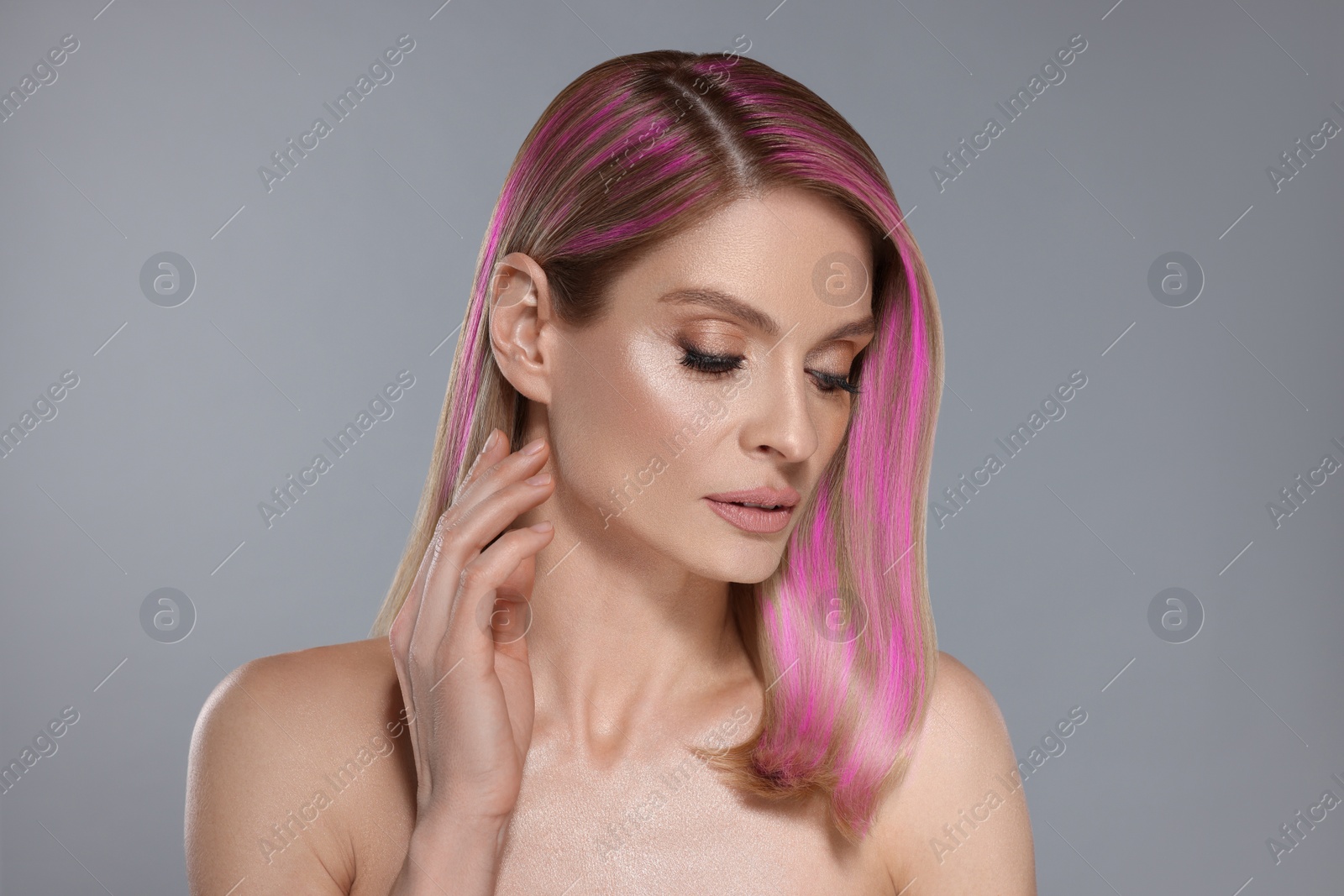 Image of Hair styling. Gorgeous woman with colorful hair on grey background