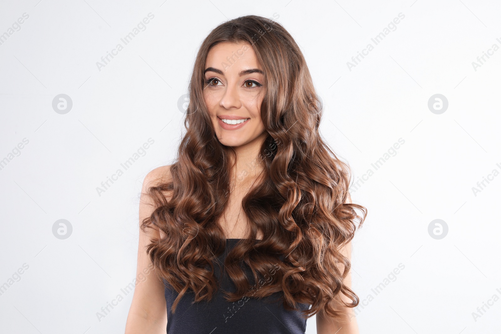 Photo of Beautiful woman with shiny wavy hair on white background