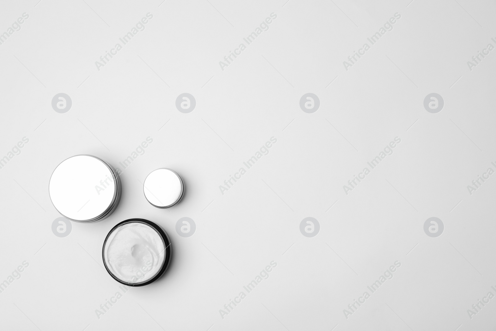 Photo of Flat lay composition with cosmetic products on light background