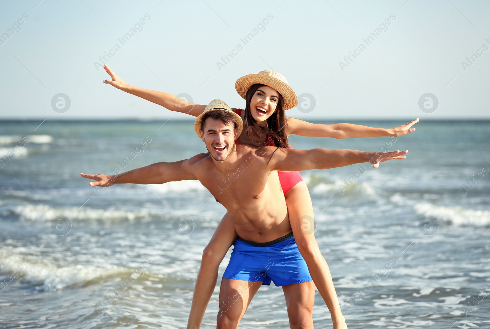 Photo of Happy young couple having fun at beach on sunny day