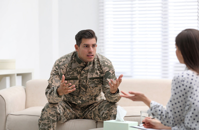 Psychotherapist working with male military officer in office